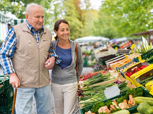 Senior man with caregiver shopping