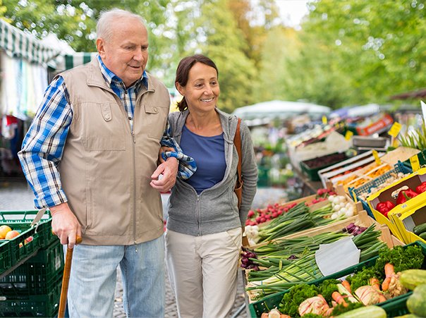 Senior man with caregiver shopping